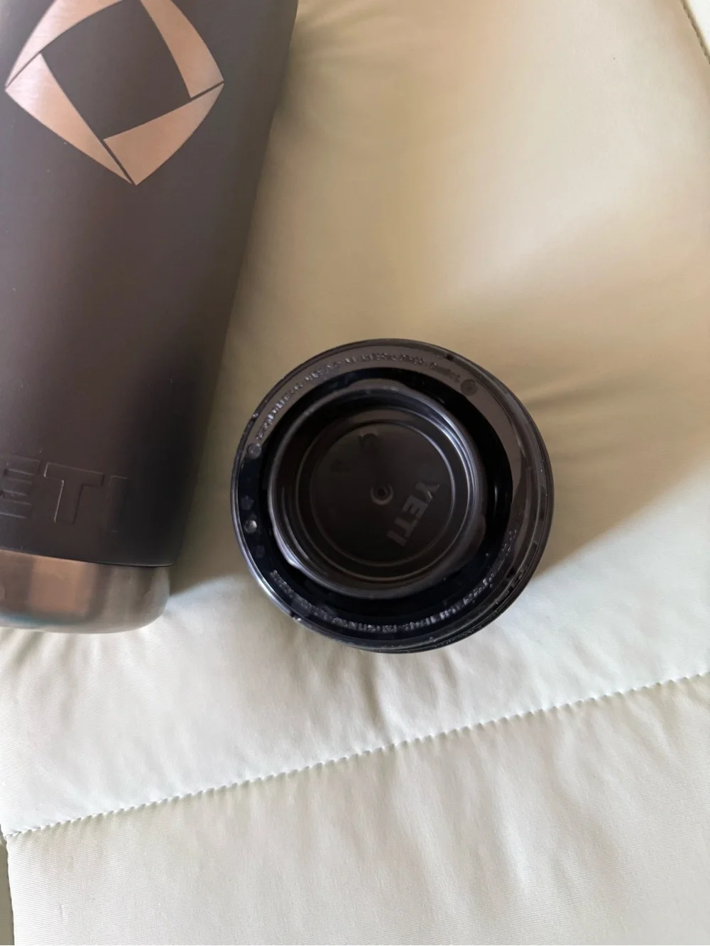 YETI Black and Silver Travel Bottle/ Rambler 18 oz Bottle in a charcoal